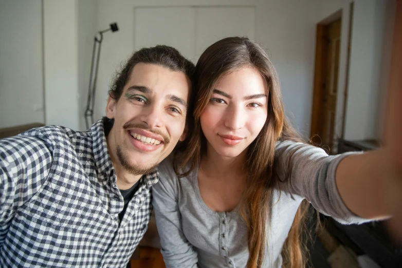 a woman and man take a selfie