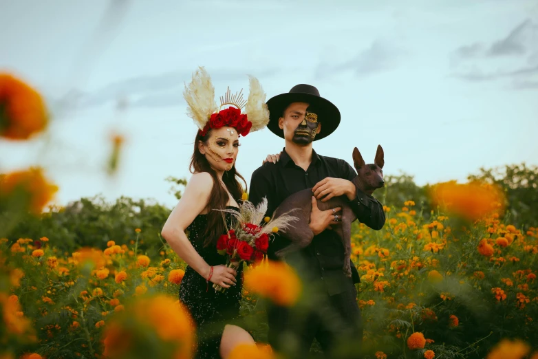 a man and woman that are standing in the grass