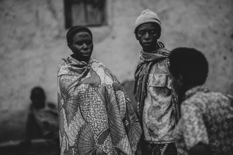 two young women standing in the middle of a crowd of men