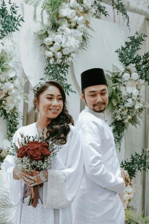 an elegantly dressed couple in traditional garb and veils