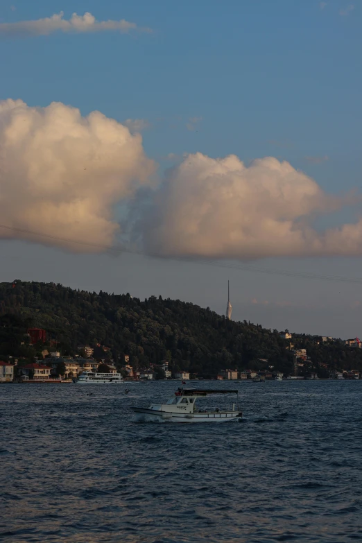 a couple of boats out on the water near a city