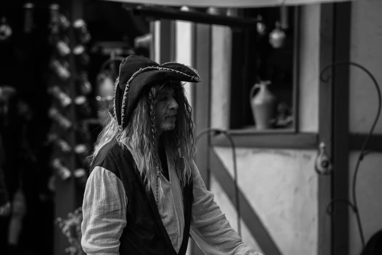 a man dressed as a pirate and holding a large knife