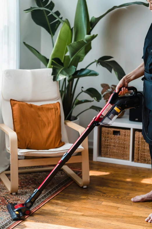 a woman vacuuming the floor with the electric mop