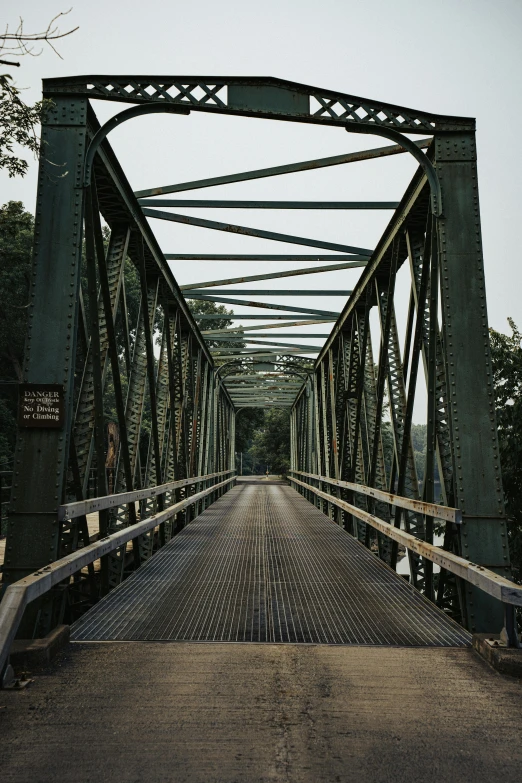 an old looking bridge has many metal beams