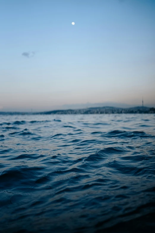 view of calm blue ocean water on a hazy day