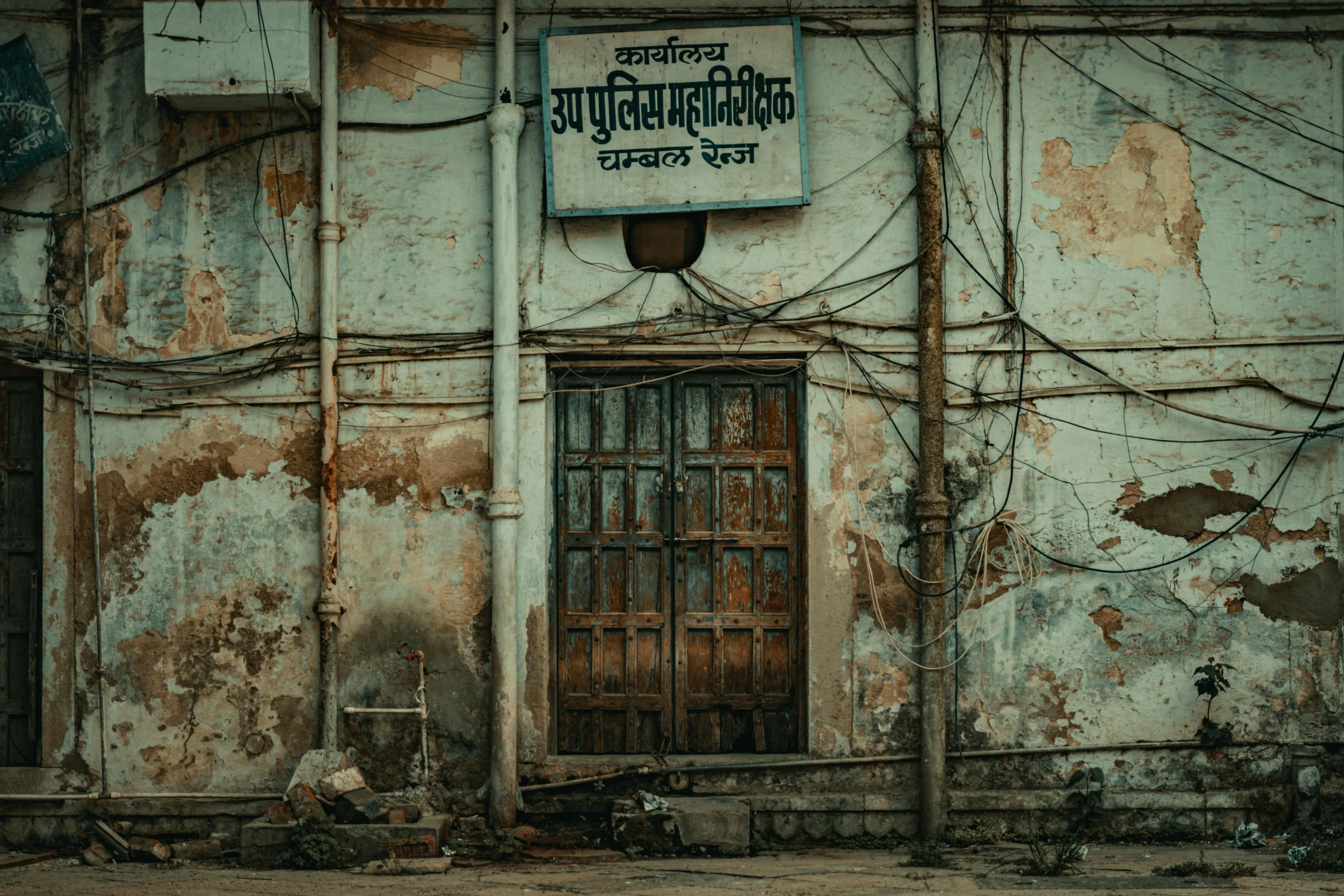 a street sign is hanging on an old building