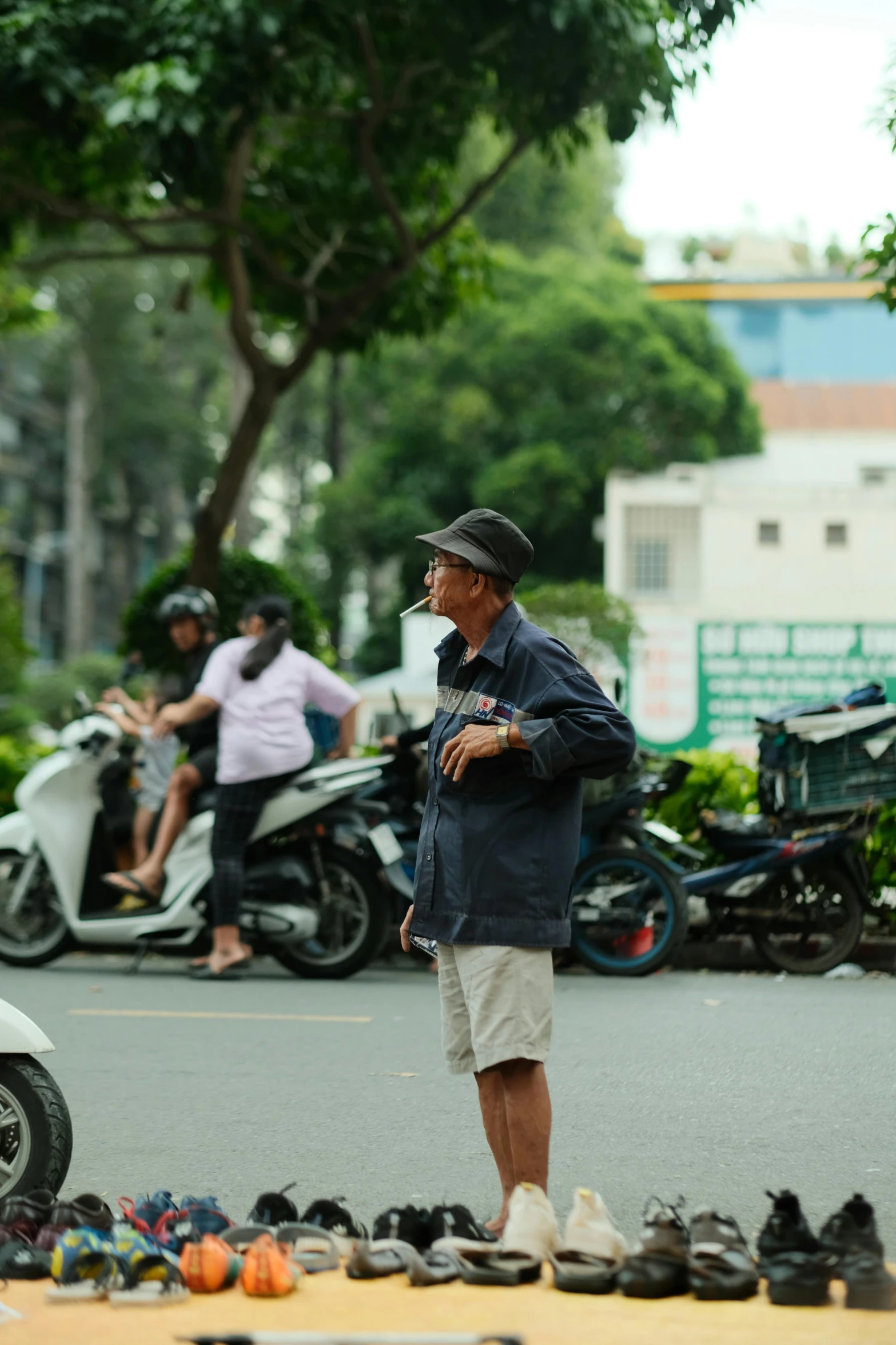 a man standing next to a bunch of shoes