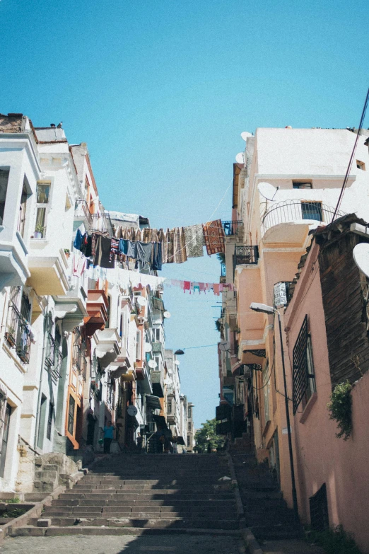 a group of clothes strung across street and buildings on the hill