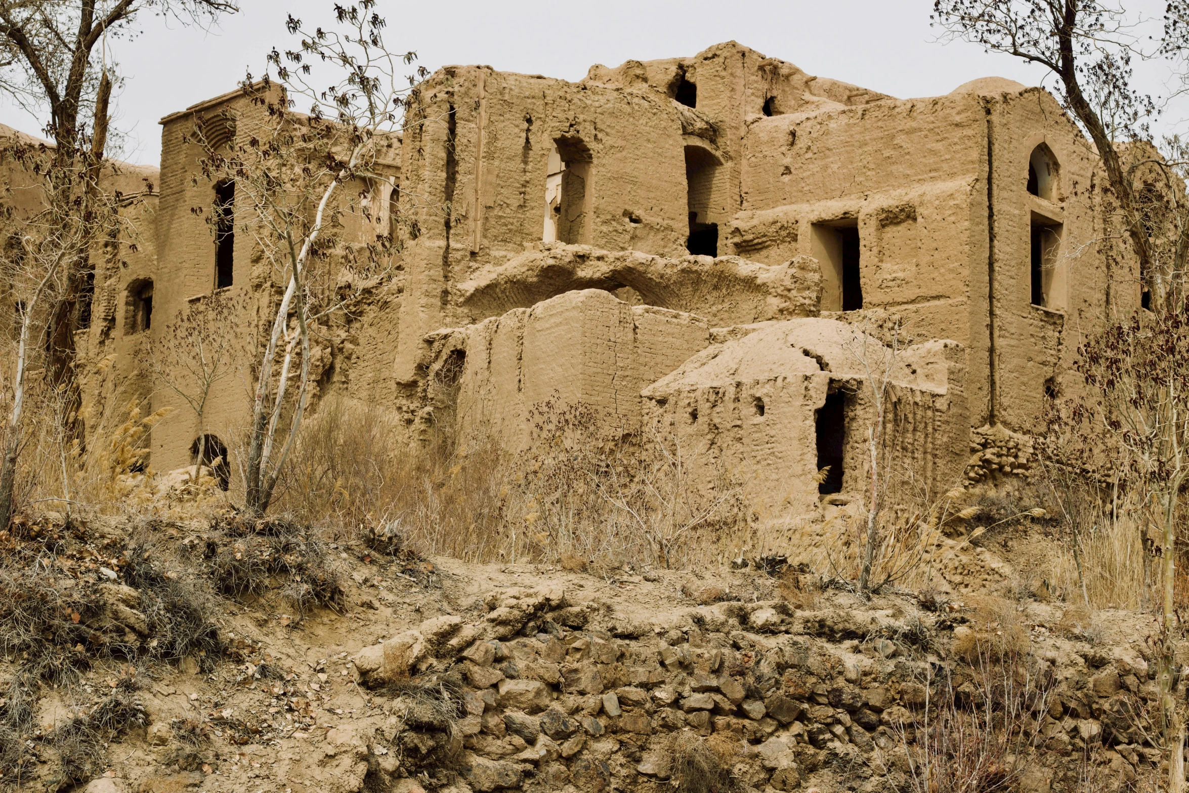 a brown adobe building made from a single block of brick