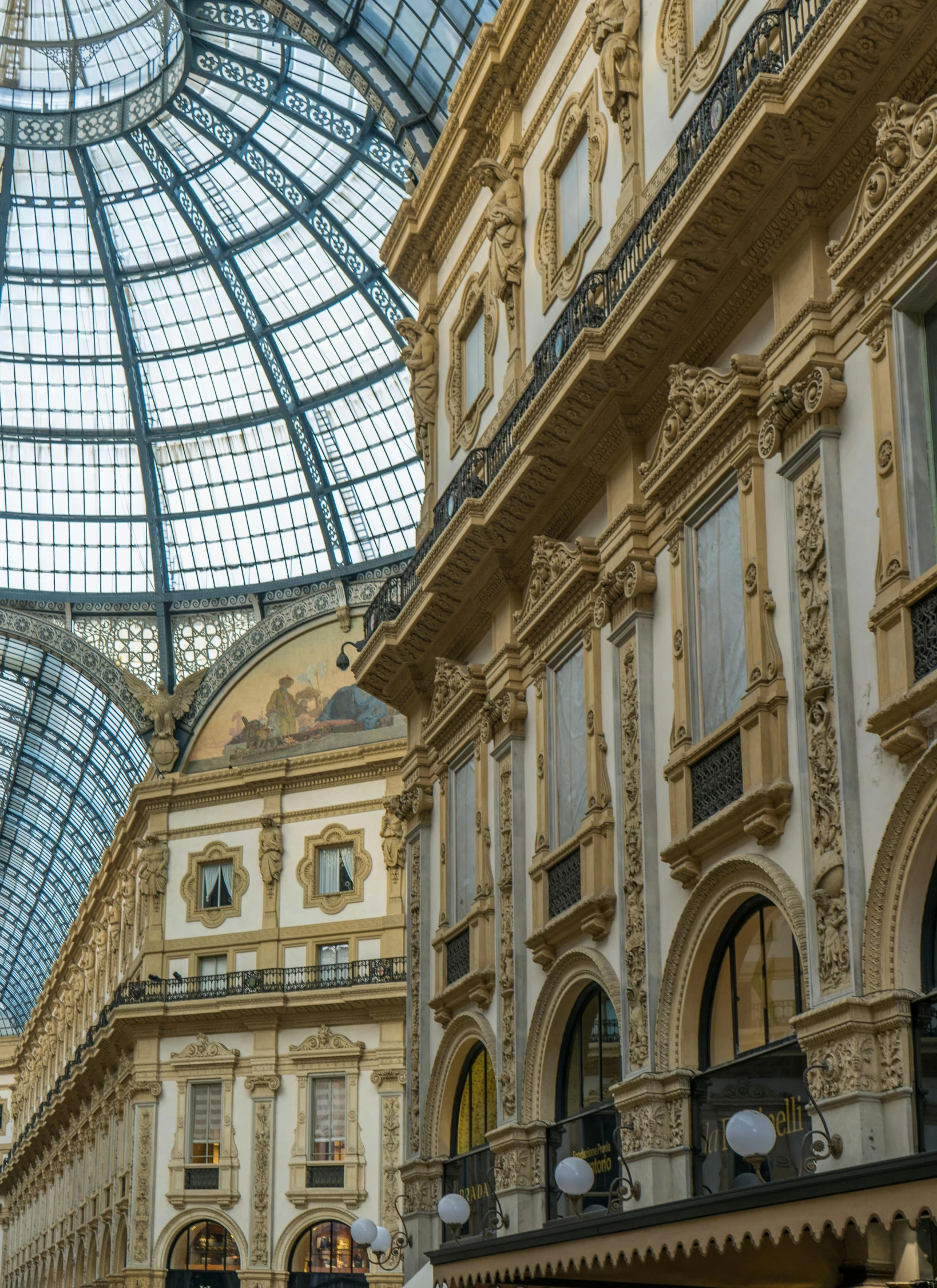 a very tall, ornately decorated building with glass ceiling