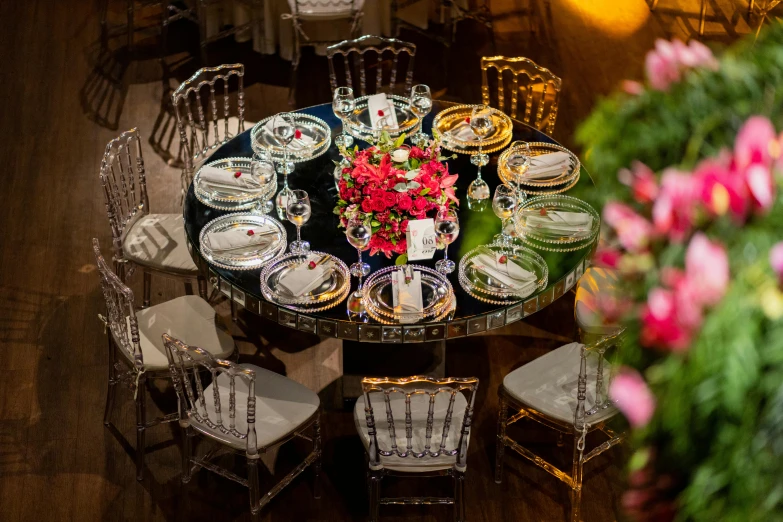 a large dinner table with many plates and silverware, is set with a centerpiece, centerpiece and floral centerpieces