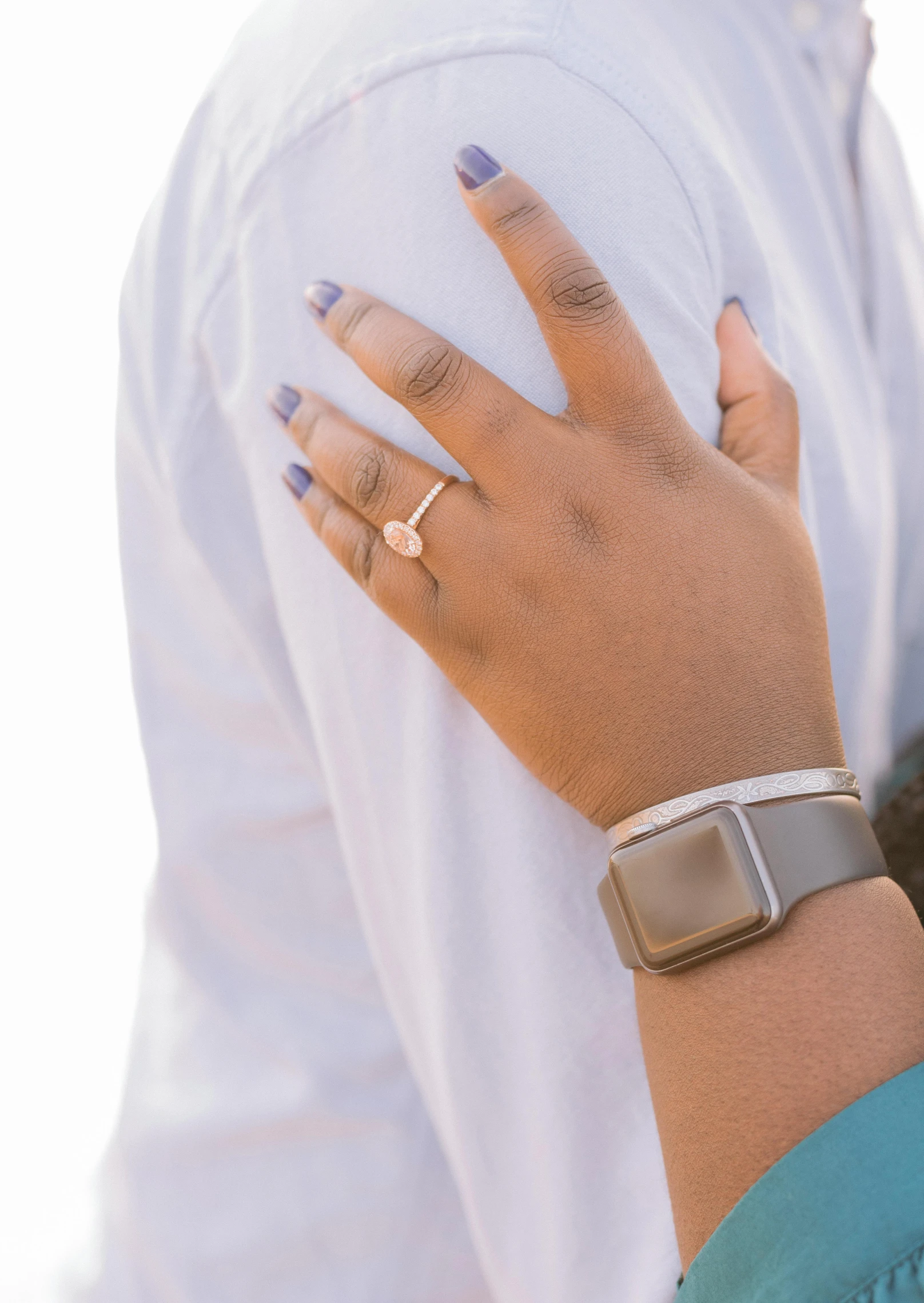 a woman's hand and wrist with two rings