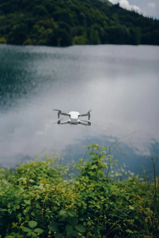 a camera attached to a quadrupular aerial device floating in a lake