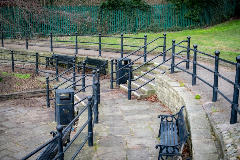 there is a park bench next to a fence