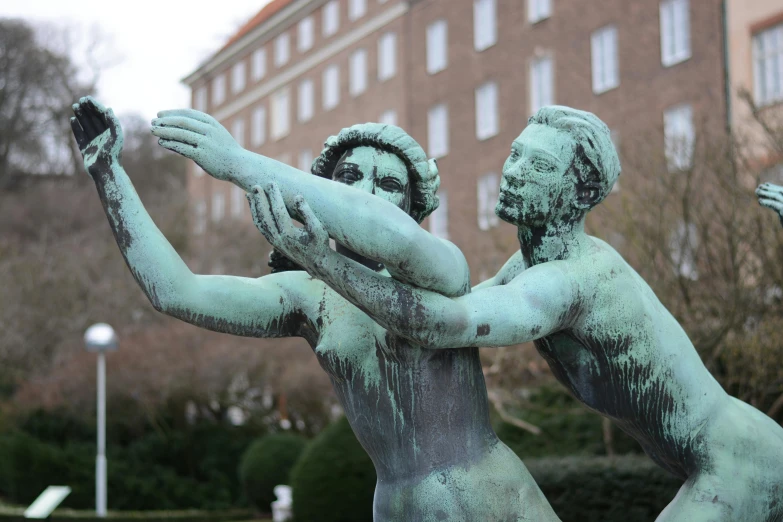 a statue of a couple with their arms stretched