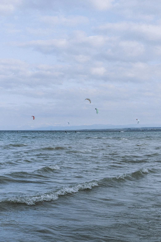 an ocean view with people parasailing in the sky