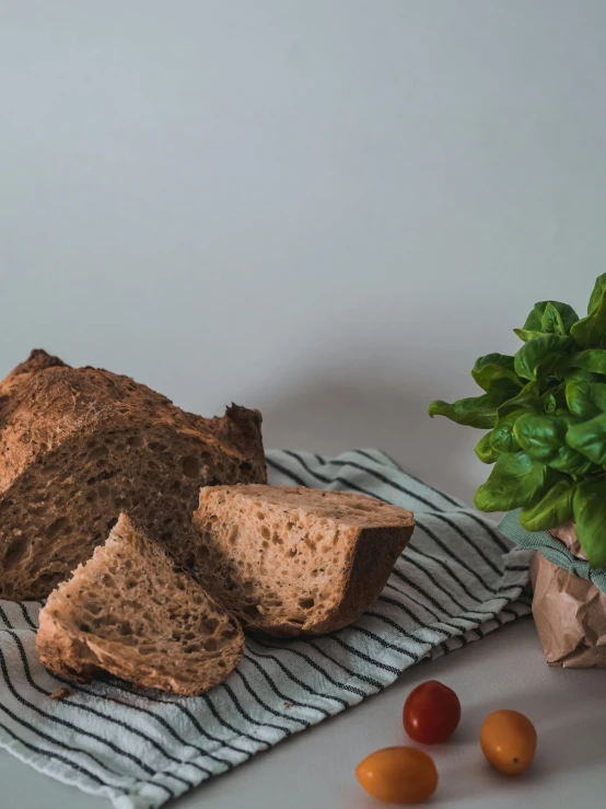 a close up of sliced bread on a table with tomatoes