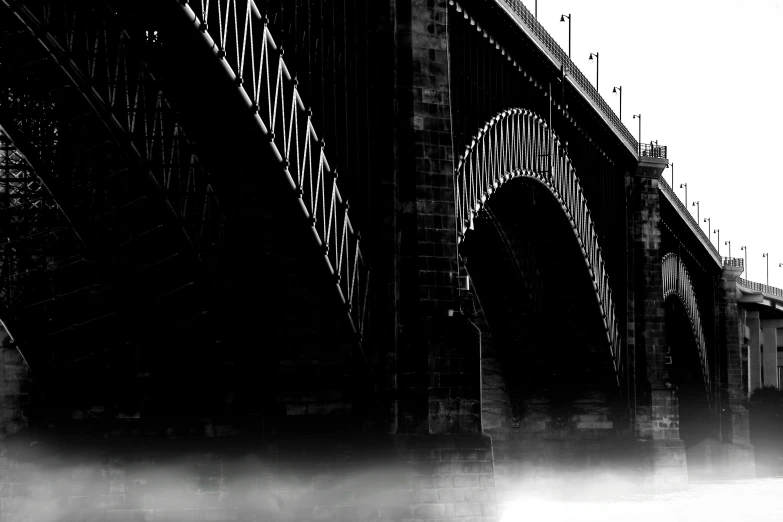 black and white pograph of bridge and water