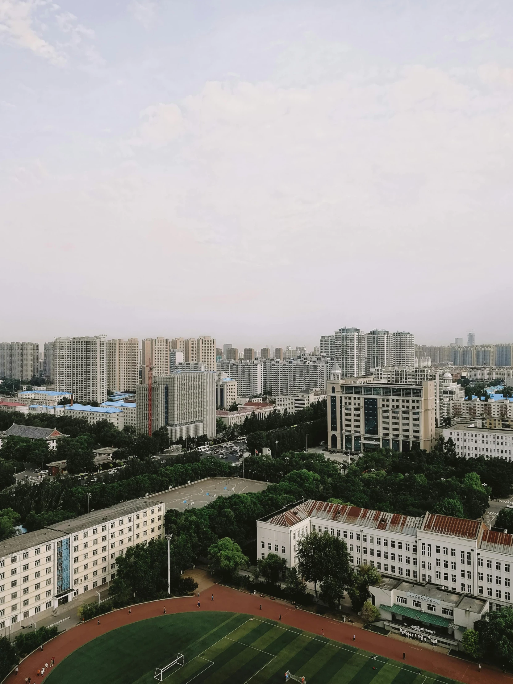 a large white building and grassy area on top of a hill