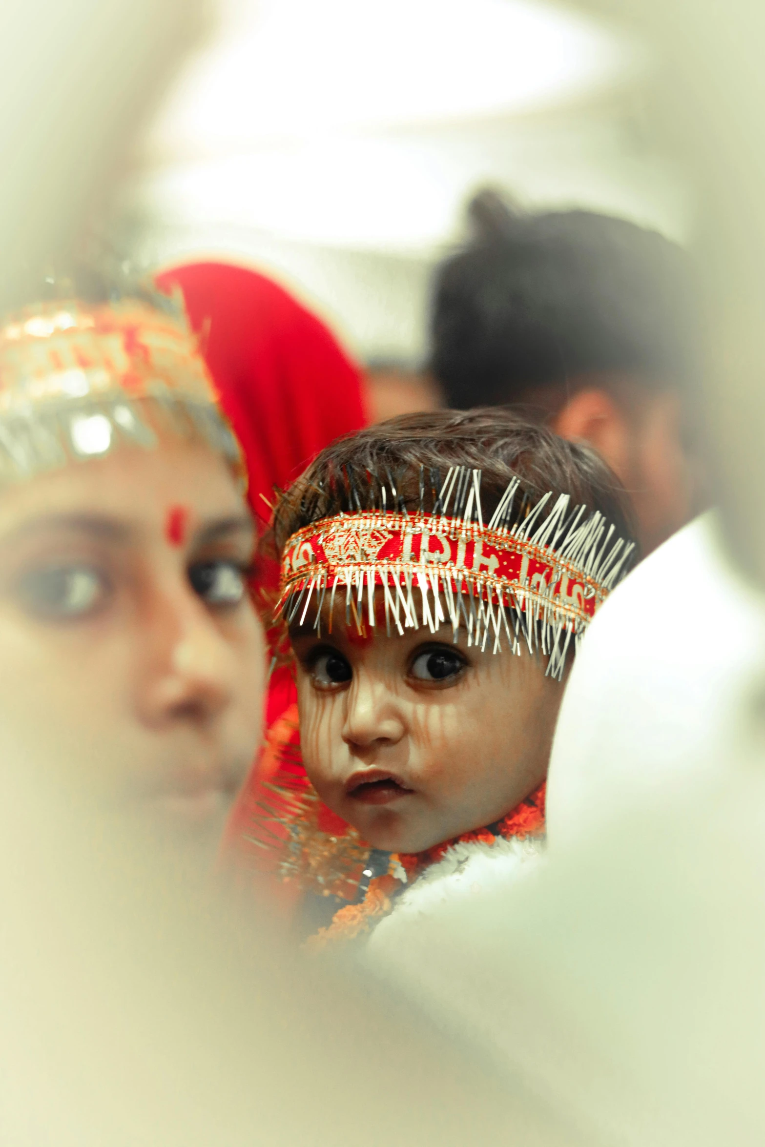 a child wearing a head piece in an indian style setting