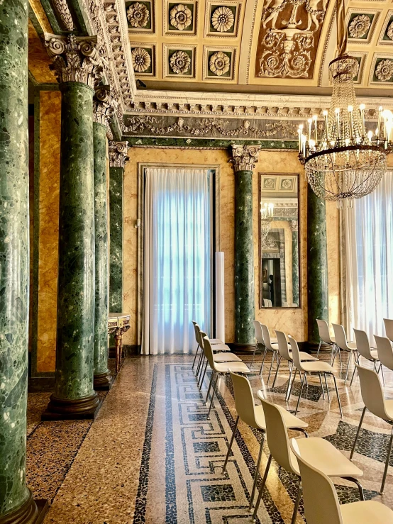 the room is full of long tables and chairs