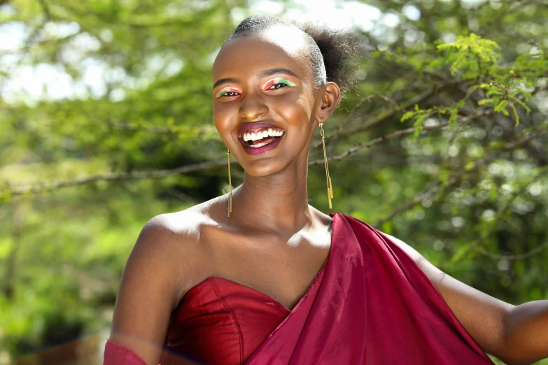 there is a beautiful woman wearing a red gown and smiling