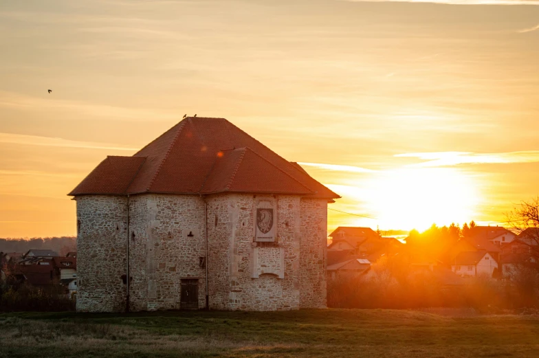 a rural village has sunsets over a small building