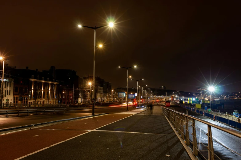 a city street at night with traffic on the road