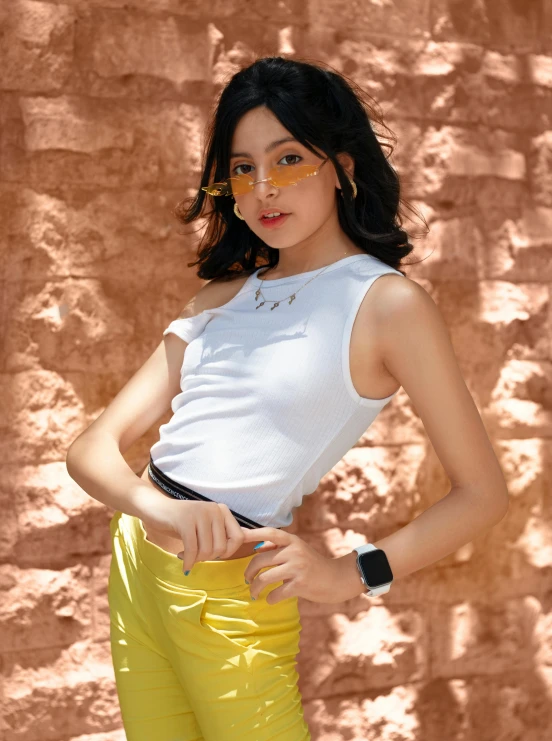 a girl standing in yellow pants and holding soing in her hand