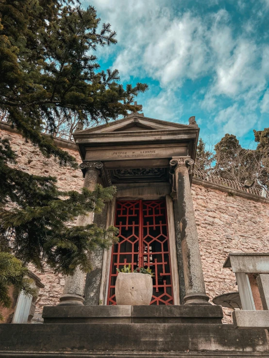 a stone shrine with carved doors and window