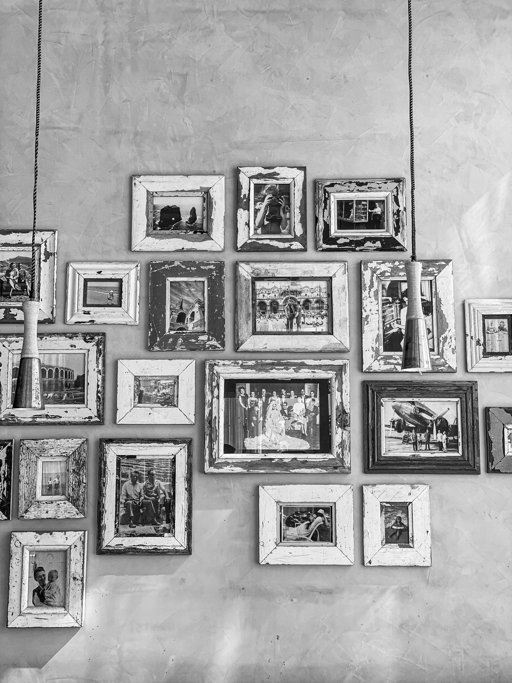 a lot of picture frames hanging on a wall