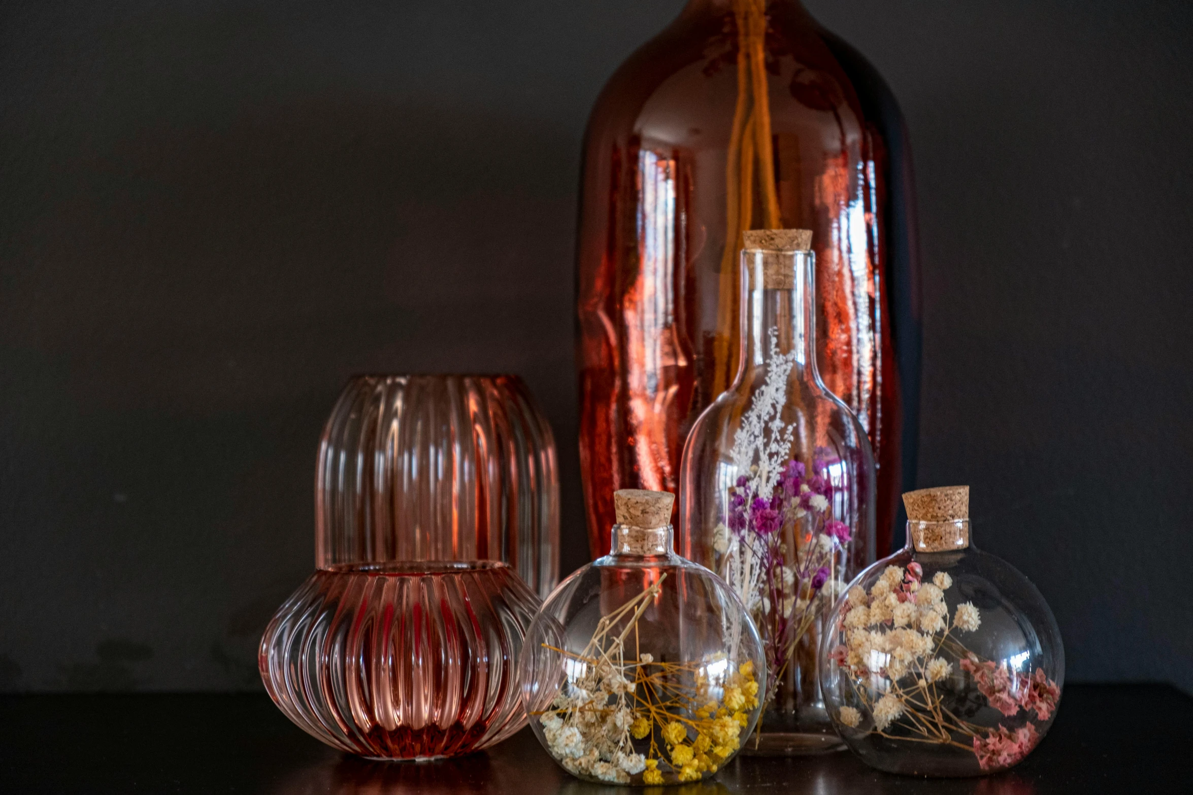 some glass bottles and flowers are sitting next to each other