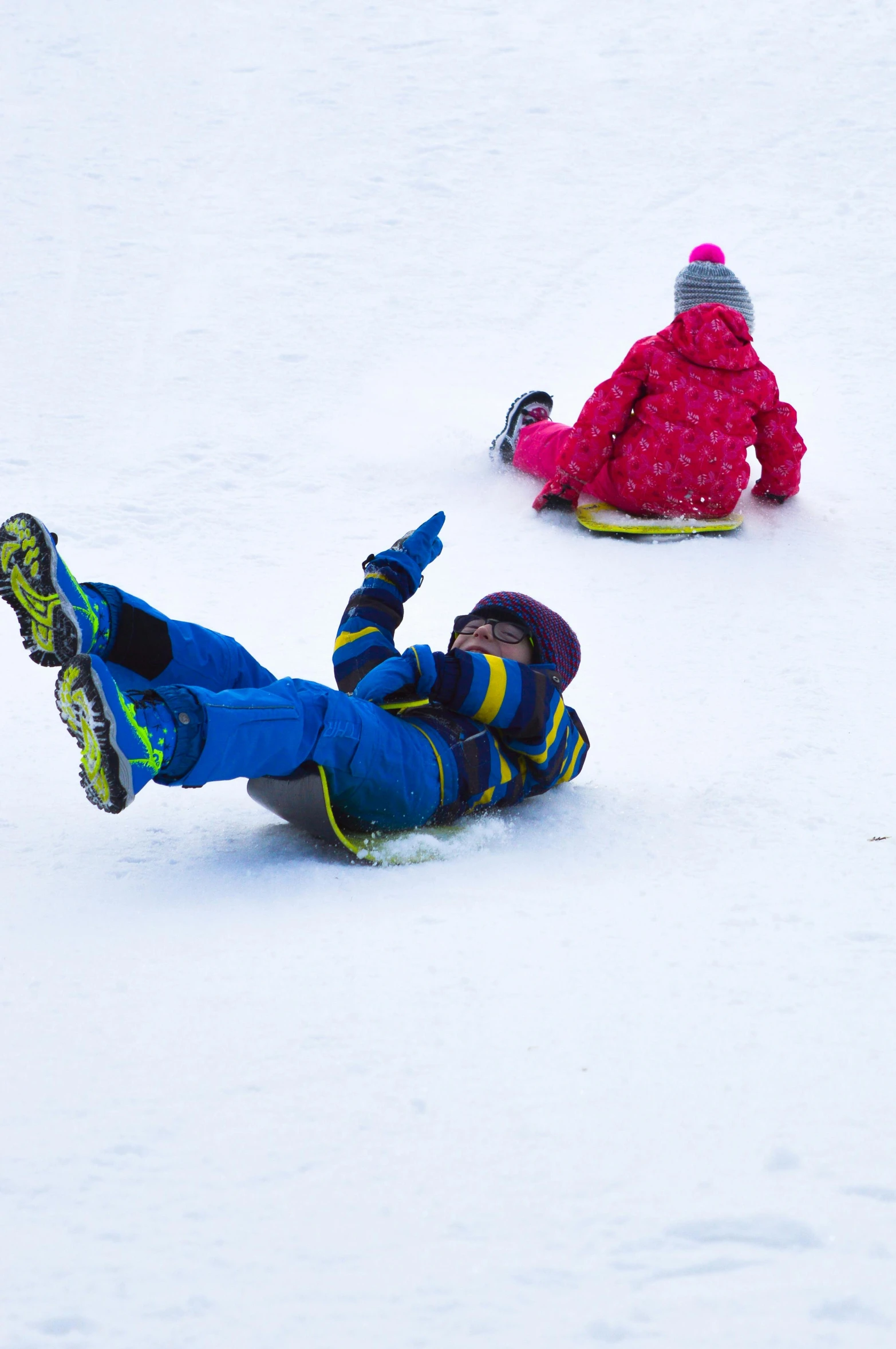 two s playing in the snow on skis