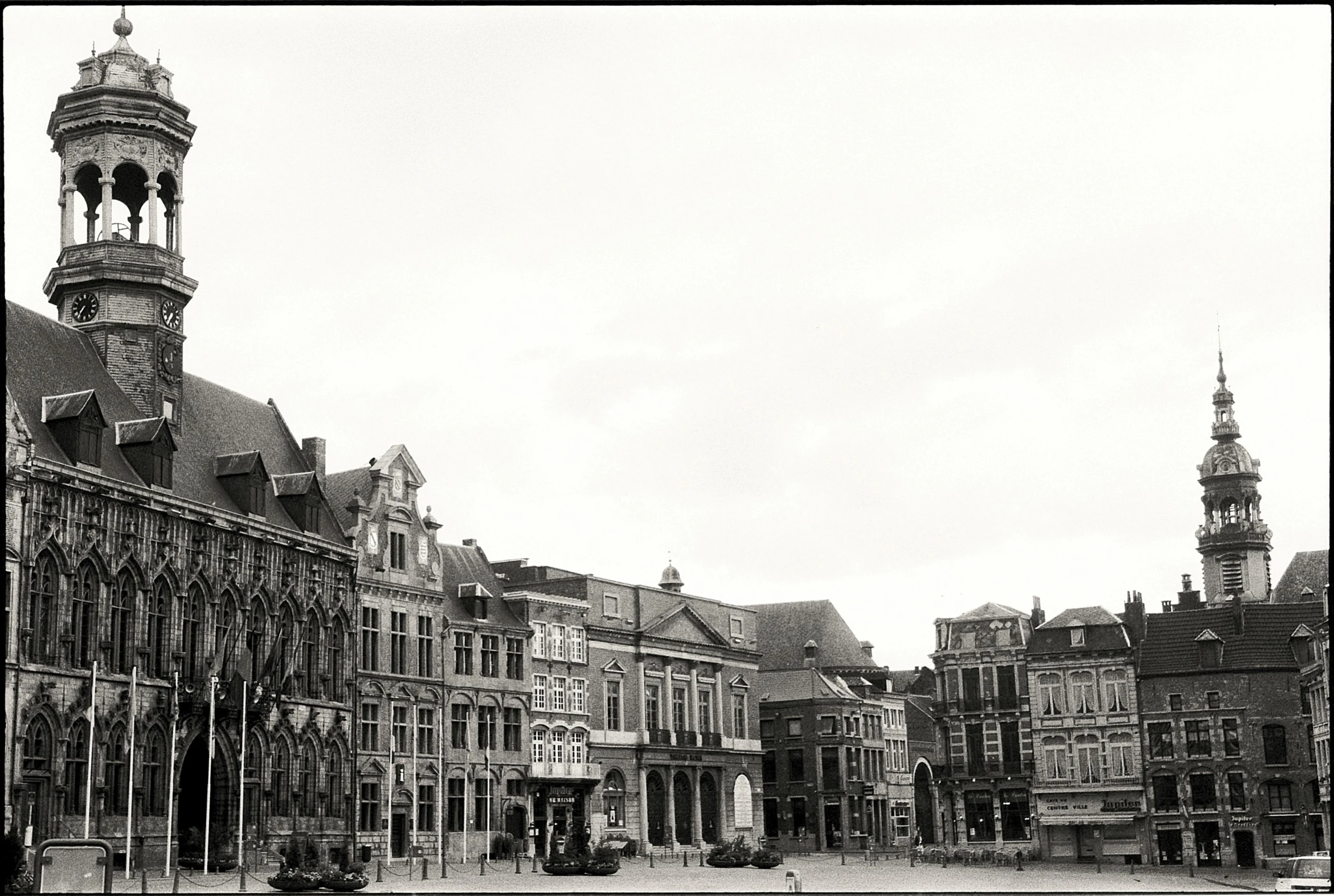 an old black and white picture of buildings and clock towers