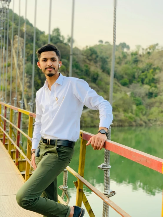 man standing on a bridge looking at the camera