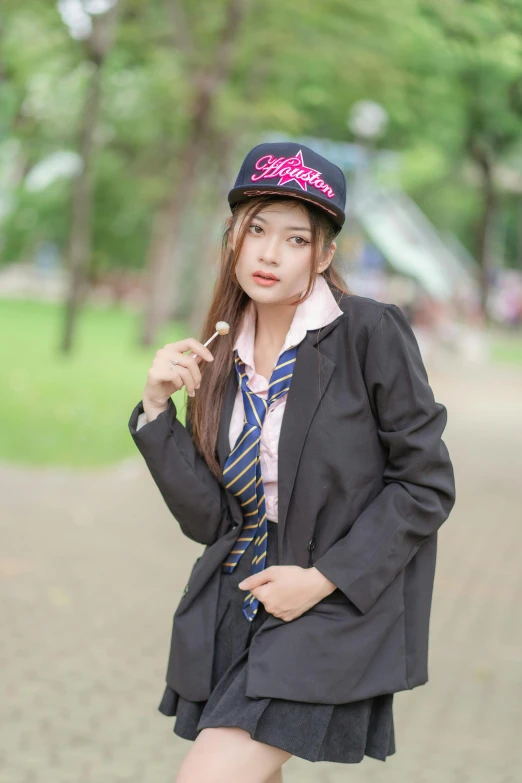 a young asian woman dressed up in a school girl uniform