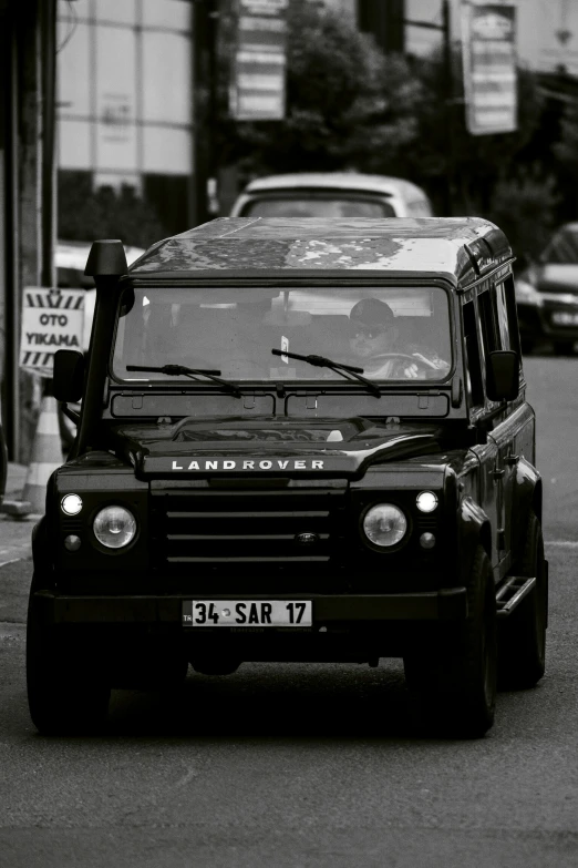 an suv driving down the street in traffic