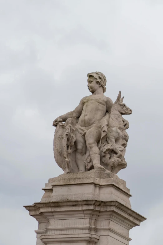 a statue of a man with two animals and a horse