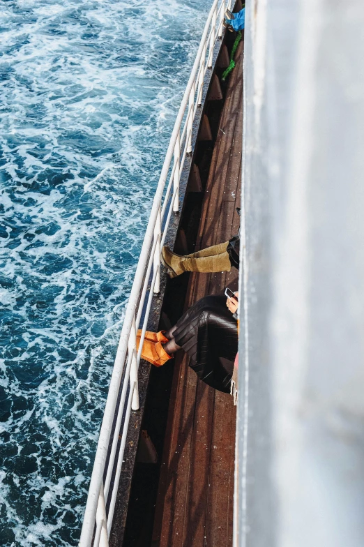 people on a pier next to the ocean