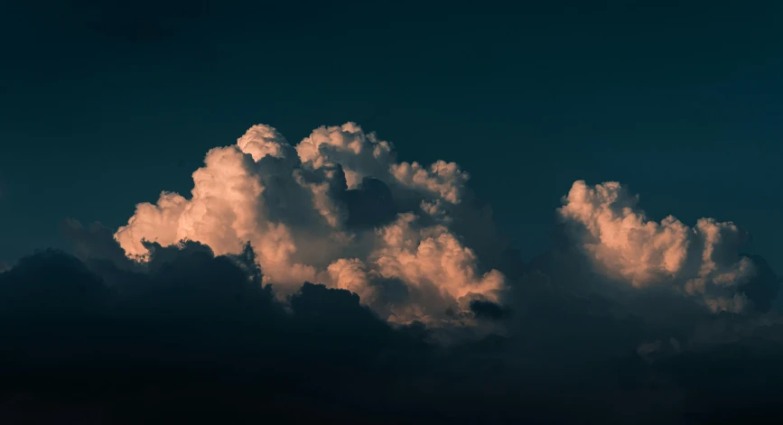 white clouds appear against a blue sky in this po