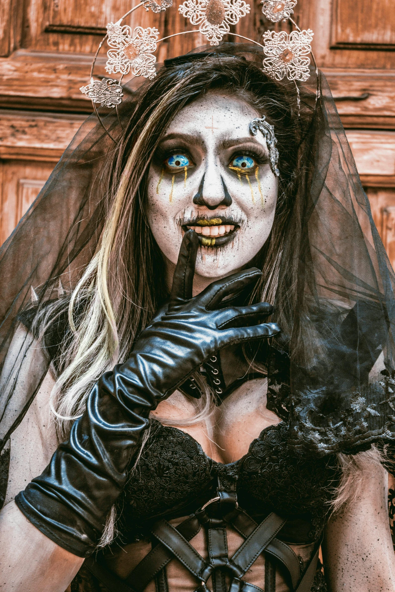 an altered pograph of a woman in white makeup and veil with her finger in her mouth