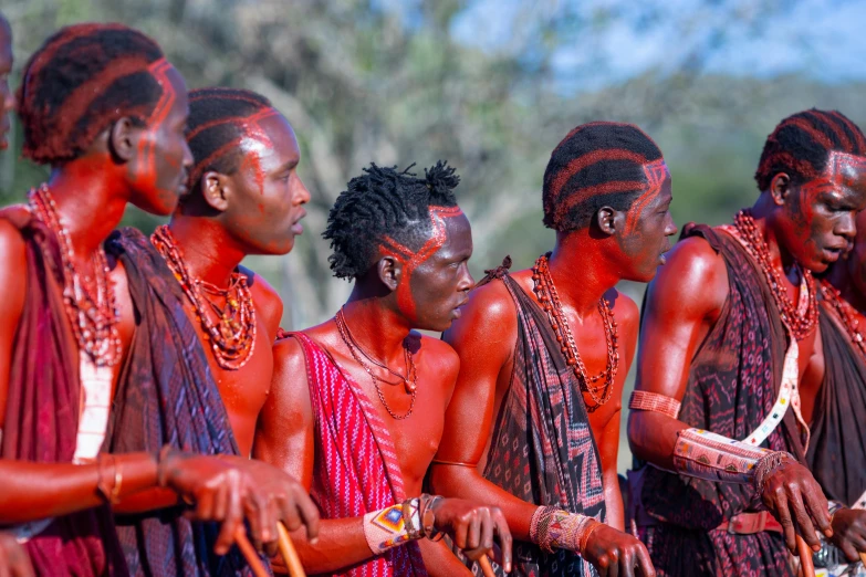 a group of young people with orange paint on their body