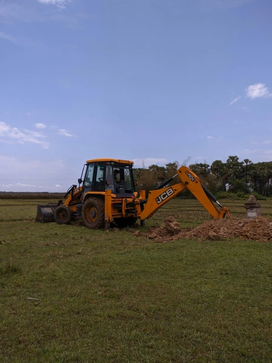 there is a large bulldozer that is in the middle of a field