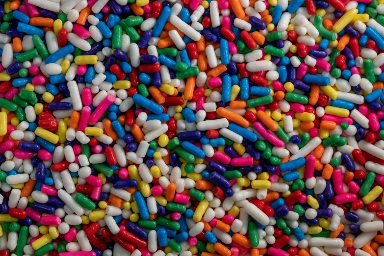 some pills and sprinkles that are multicolored