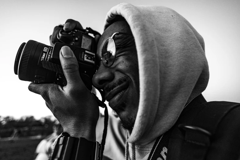 a black and white po of a man holding a camera