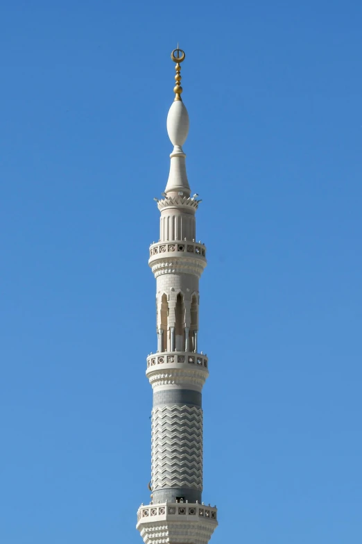 a clock on top of a very tall white tower