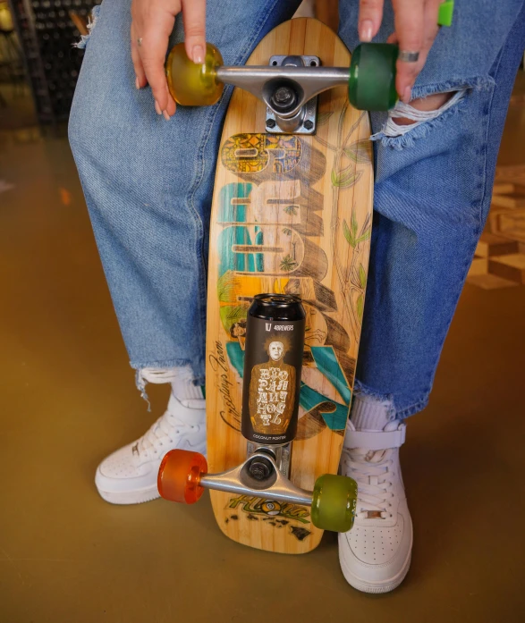 the skateboarder is sitting on his wooden board