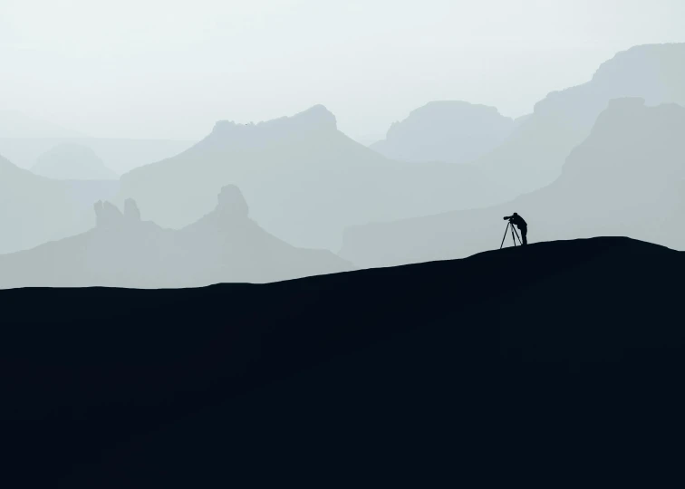 a person walking alone through a vast mountain range