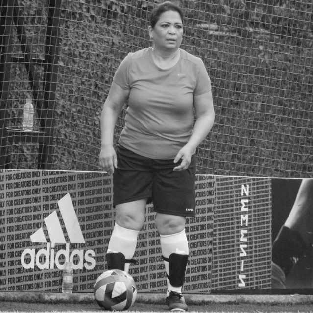 a woman is on the field playing with a soccer ball