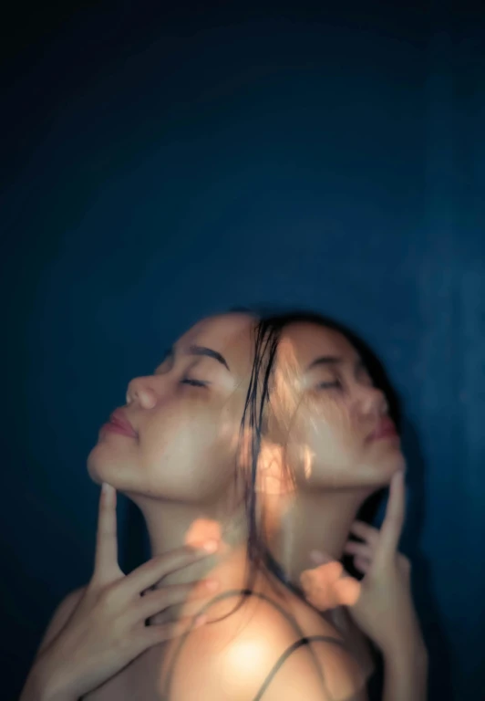 a woman standing with her head under water in the background